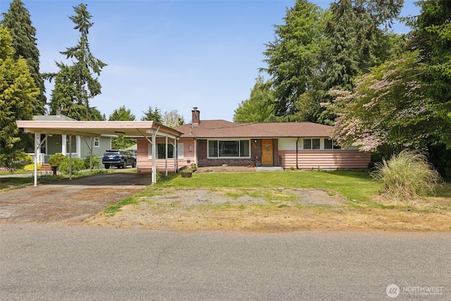 8511 31st St W, University Place, WA 98466 - view of front facade with driveway, a chimney, and a front yard