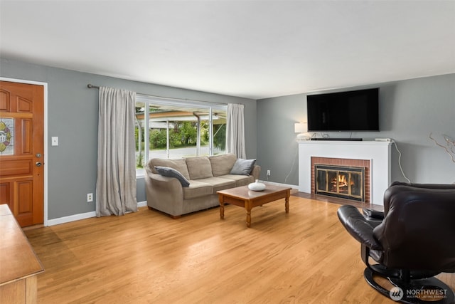 8511 31st St W, University Place, WA 98466 - living area featuring light wood finished floors, a brick fireplace, and baseboards