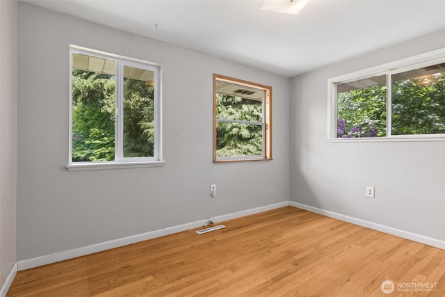 8511 31st St W, University Place, WA 98466 - spare room featuring plenty of natural light and baseboards