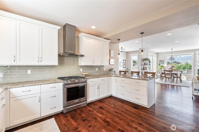 719 19th St NE, East Wenatchee, WA 98802 - kitchen with stainless steel range, wall chimney range hood, a peninsula, white cabinetry, and recessed lighting