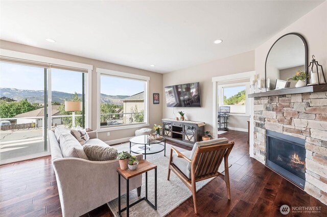 719 19th St NE, East Wenatchee, WA 98802 - living room with baseboards, a fireplace, dark wood-style floors, and recessed lighting