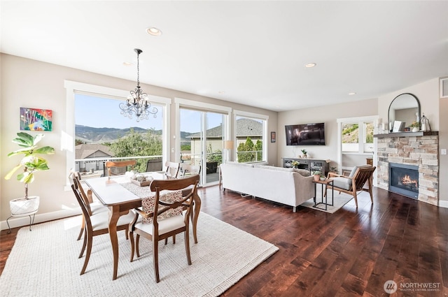 719 19th St NE, East Wenatchee, WA 98802 - dining space featuring dark wood-style floors, a chandelier, a fireplace, recessed lighting, and baseboards