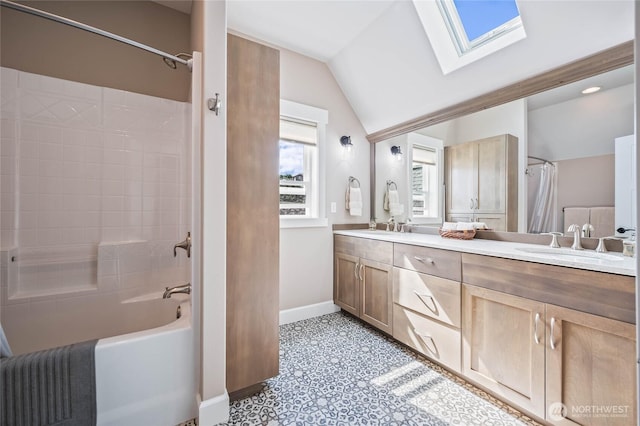 719 19th St NE, East Wenatchee, WA 98802 - full bath featuring a skylight, baseboards, double vanity, lofted ceiling, and shower / bathtub combination with curtain