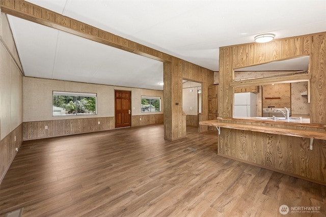 23920 50th Ave E, Graham, WA 98338 - unfurnished living room with wood walls, wood finished floors, and a sink