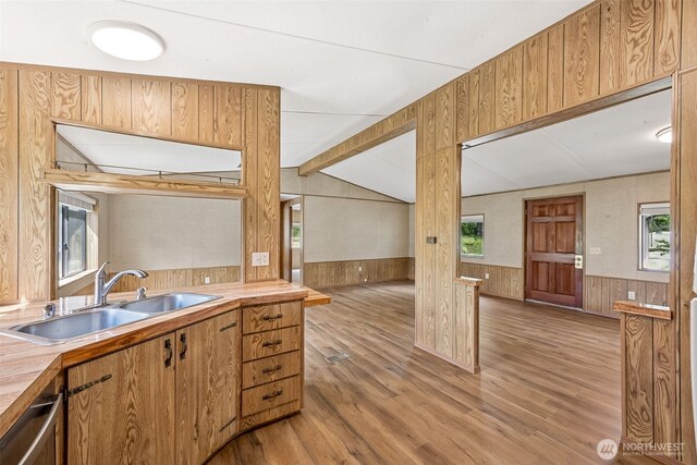 23920 50th Ave E, Graham, WA 98338 - kitchen with a sink, wood walls, light wood finished floors, a wainscoted wall, and light countertops