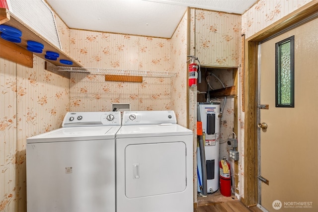 23920 50th Ave E, Graham, WA 98338 - laundry room with wallpapered walls, independent washer and dryer, water heater, and wood finished floors