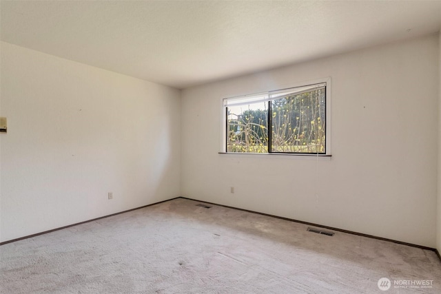 empty room with carpet and baseboards