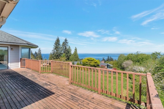 wooden terrace with a water view and a lawn