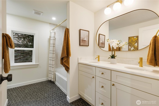 bathroom with double vanity, baseboards, and shower / bath combination with curtain