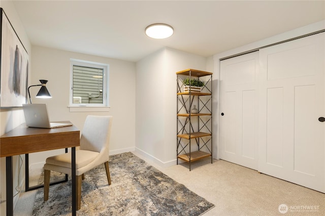 carpeted office featuring baseboards