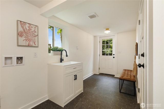 washroom featuring washer hookup and baseboards