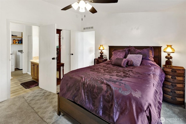 7135 W 40th Dr, Ferndale, WA 98248 - bedroom with vaulted ceiling, separate washer and dryer, ensuite bathroom, light wood-type flooring, and a ceiling fan