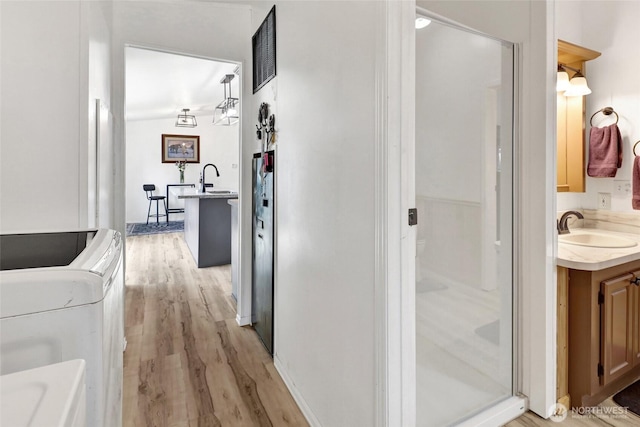 7135 W 40th Dr, Ferndale, WA 98248 - hallway with a sink, light wood-style flooring, and washer / dryer