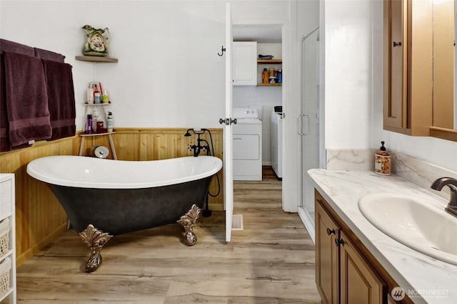 7135 W 40th Dr, Ferndale, WA 98248 - full bath with separate washer and dryer, vanity, wood finished floors, a wainscoted wall, and wood walls