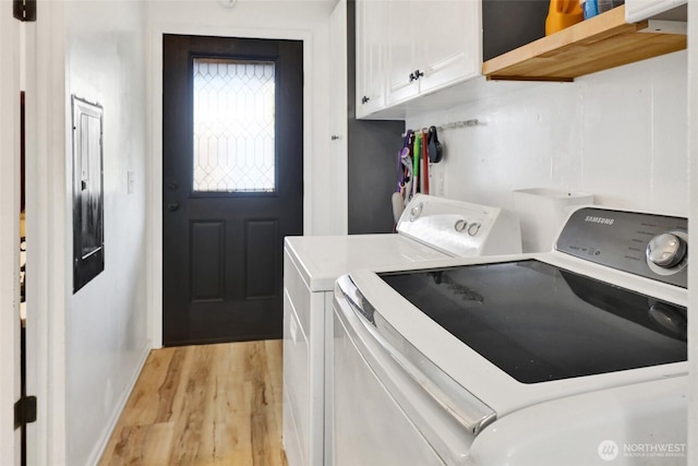 7135 W 40th Dr, Ferndale, WA 98248 - laundry room with washing machine and dryer, light wood-style flooring, and cabinet space