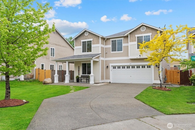 9604 201st Street Ct E, Graham, WA 98338 - view of front of house featuring a porch, concrete driveway, a garage, and board and batten siding