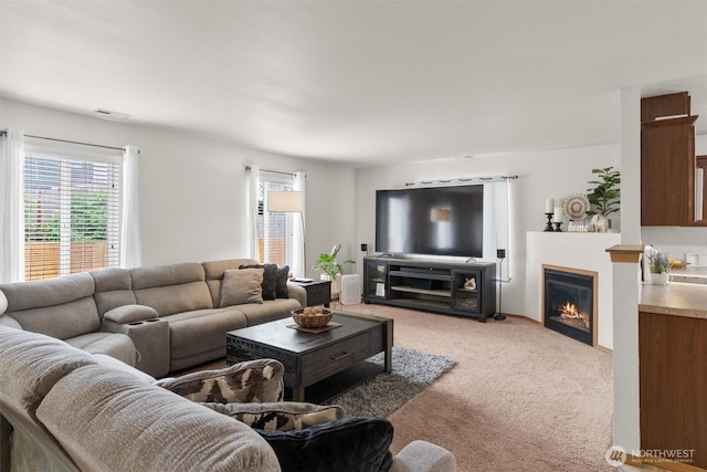 9604 201st Street Ct E, Graham, WA 98338 - living area featuring light carpet, healthy amount of natural light, and a glass covered fireplace