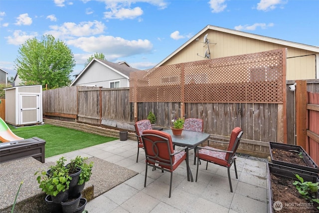 9604 201st Street Ct E, Graham, WA 98338 - fenced backyard with a patio, outdoor dining space, and a storage shed