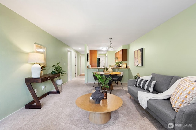 11307 NE 128th St Unit G204, Kirkland, WA 98034 - living room featuring light colored carpet and baseboards