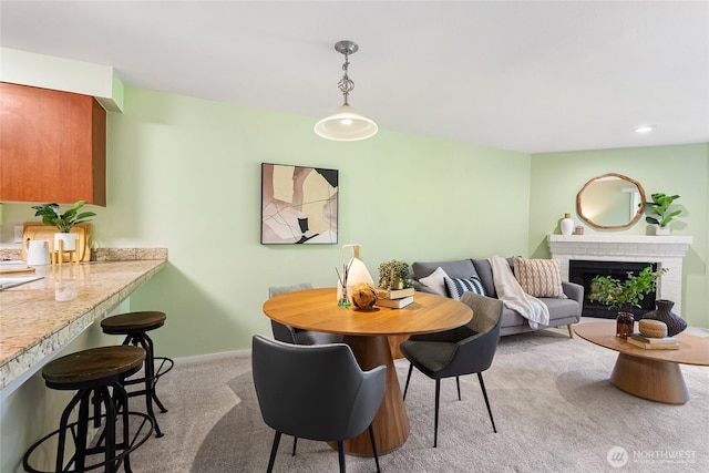 11307 NE 128th St Unit G204, Kirkland, WA 98034 - dining room featuring light colored carpet, baseboards, a fireplace, and recessed lighting