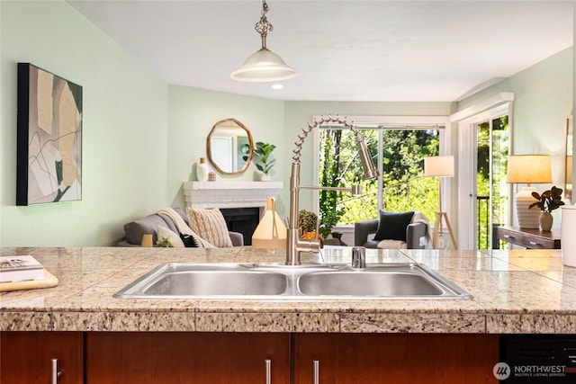 11307 NE 128th St Unit G204, Kirkland, WA 98034 - kitchen featuring a fireplace, hanging light fixtures, dishwashing machine, and tile countertops