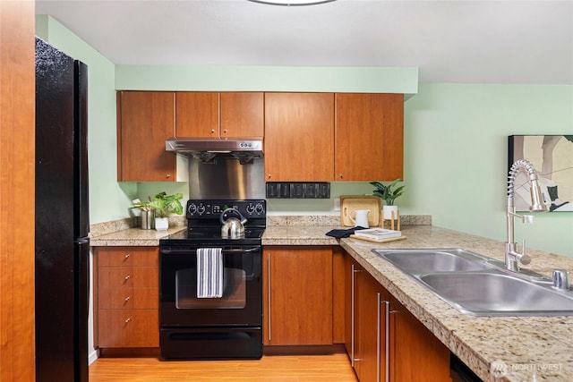 11307 NE 128th St Unit G204, Kirkland, WA 98034 - kitchen with black appliances, a sink, under cabinet range hood, and light countertops