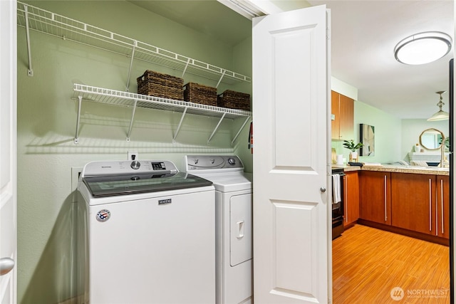 11307 NE 128th St Unit G204, Kirkland, WA 98034 - laundry room with separate washer and dryer and light wood finished floors