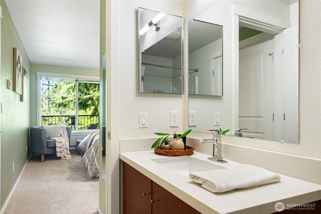11307 NE 128th St Unit G204, Kirkland, WA 98034 - bathroom featuring vanity, baseboards, and ensuite bath