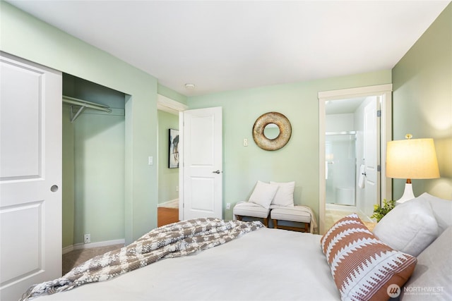 11307 NE 128th St Unit G204, Kirkland, WA 98034 - carpeted bedroom featuring a closet, connected bathroom, and baseboards