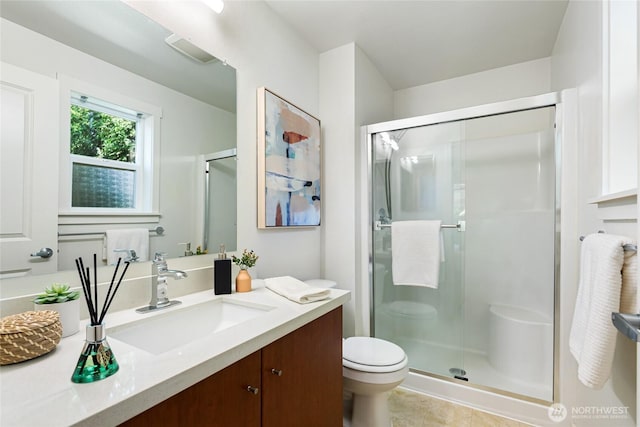 11307 NE 128th St Unit G204, Kirkland, WA 98034 - bathroom with toilet, vanity, a shower stall, and tile patterned flooring