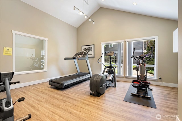 11307 NE 128th St Unit G204, Kirkland, WA 98034 - workout room with wood finished floors, high vaulted ceiling, and baseboards