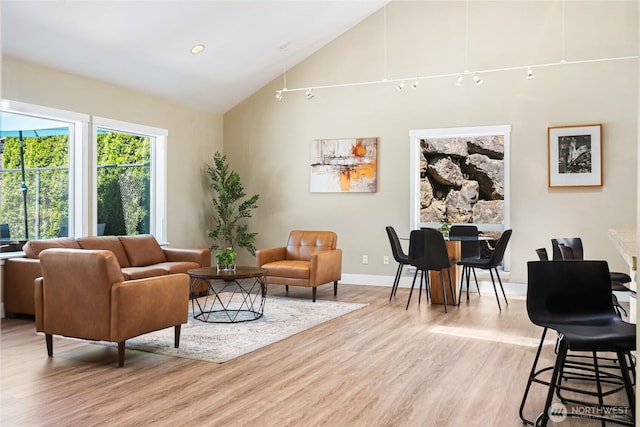 11307 NE 128th St Unit G204, Kirkland, WA 98034 - living room with light wood-style flooring, high vaulted ceiling, and baseboards