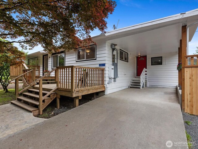 28611 139th Ave NE, Arlington, WA 98223 - view of front of home featuring entry steps, an attached carport, and a wooden deck