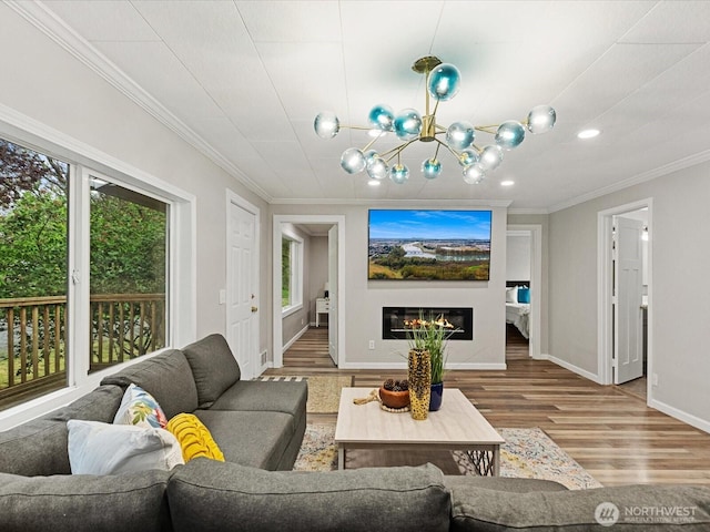 28611 139th Ave NE, Arlington, WA 98223 - living room featuring healthy amount of natural light, ornamental molding, wood finished floors, baseboards, and a glass covered fireplace