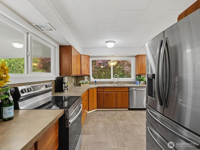 28611 139th Ave NE, Arlington, WA 98223 - kitchen with stainless steel appliances, a sink, brown cabinets, and light countertops
