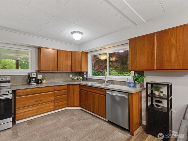 28611 139th Ave NE, Arlington, WA 98223 - kitchen with stainless steel appliances, a sink, brown cabinets, and healthy amount of natural light