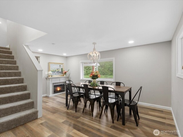 28611 139th Ave NE, Arlington, WA 98223 - dining space featuring stairway, wood finished floors, recessed lighting, a glass covered fireplace, and baseboards