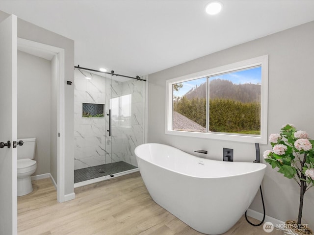 28611 139th Ave NE, Arlington, WA 98223 - bathroom featuring a marble finish shower, toilet, wood finished floors, a soaking tub, and recessed lighting