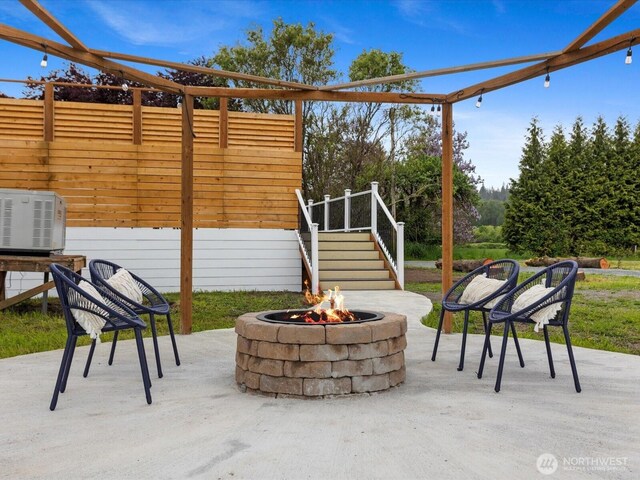 28611 139th Ave NE, Arlington, WA 98223 - view of patio featuring an outdoor fire pit, stairway, and fence