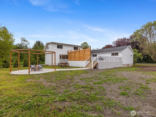 28611 139th Ave NE, Arlington, WA 98223 - rear view of property featuring a deck, a patio area, a pergola, a yard, and board and batten siding