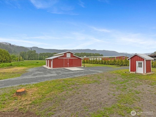 28611 139th Ave NE, Arlington, WA 98223 - view of green lawn with a mountain view, an outbuilding, a barn, and a detached garage