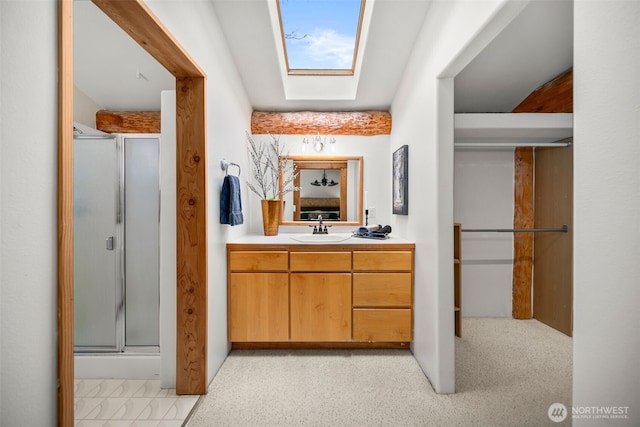 full bathroom featuring a skylight, a shower stall, vanity, and carpet