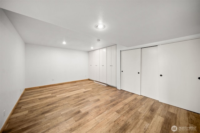 unfurnished bedroom featuring light wood-type flooring, recessed lighting, and baseboards