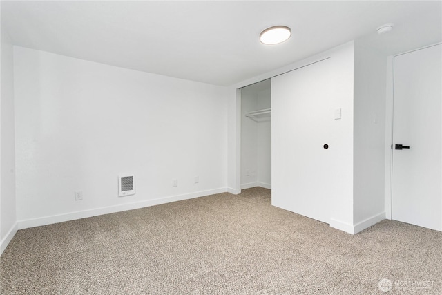 unfurnished bedroom featuring carpet floors, a closet, and baseboards