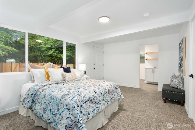 bedroom featuring carpet floors, beamed ceiling, and baseboards