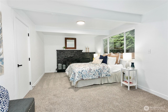 bedroom featuring baseboards, carpet floors, a fireplace, and beam ceiling