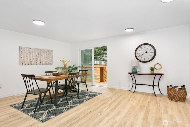 dining room with wood finished floors and baseboards