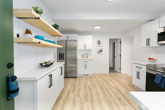 kitchen featuring stainless steel appliances, open shelves, light countertops, white cabinetry, and light wood-type flooring