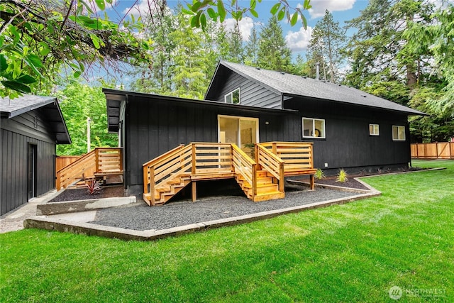 rear view of property featuring a deck and stairs