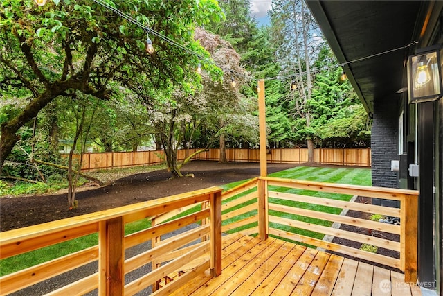 wooden terrace featuring view of wooded area